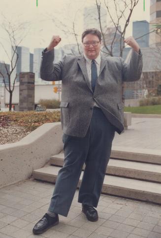 Heavyweight Champ: Peter Hay flexes muscles after winning fight with Toronto Dominion Bank over his weight