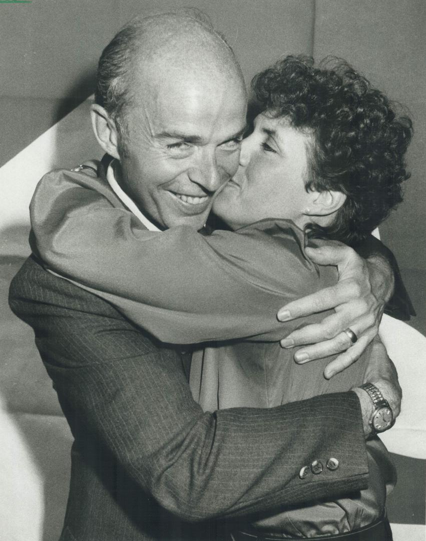 How sweet it is: Liberal candidate Jim Henderson gets a hug from his wife Karen after his upset victory in Humber riding over Environment Minister Morley Kells