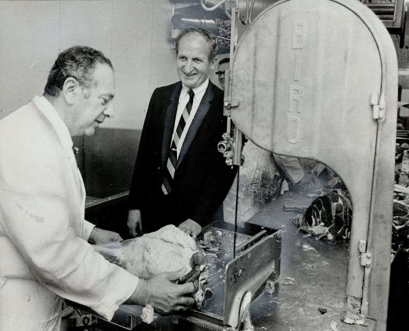 Meat is the mainstay in any supermarket operation: Mottle Goodbaum, right, who helped open two new Sunnybrook stores in a single day, this week, here talks meat with his meat operations managing Irvin Zucker