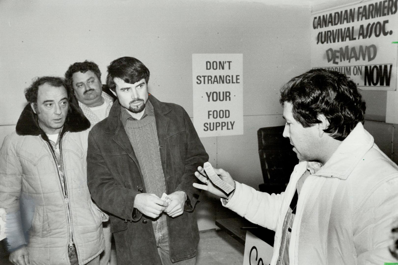 Fighting back: Lawyer John Gorman, right, examines a cheque from an anonymous donor - the first donation in a battle he's organizing against farm foreclosures