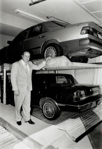 Saving space: A Toronto firm is marketing a hydraulic device that lowers one car into a five-foot-deep basement of a garage, leaving room for a second car to park in the garage at ground level