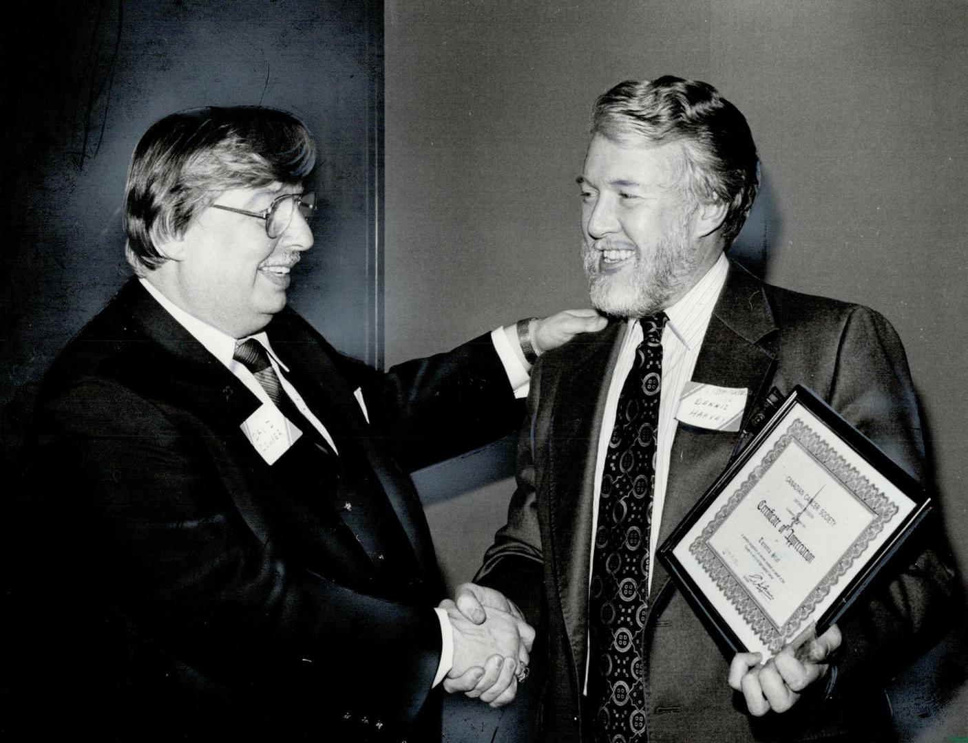 Cancer award, Representatives of the three Toronto newspapers and the Metro Toronto Police received certificates of appreciation from David Bruce Cowper, the Canadian Cancer Society's Toronto unit campaign chairman, for their help in raising a record $1,456,175 in Toronto alone