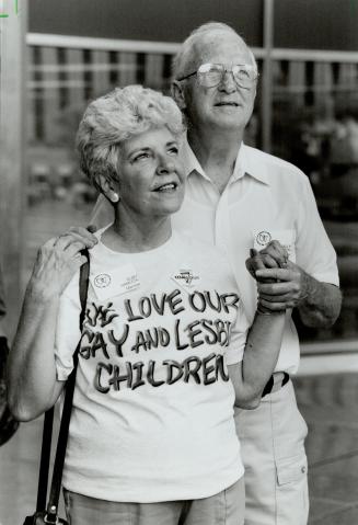 Flag flying: Ruby and Wally Hamilton of Scarborough watch as rainbow flag is raised for first time at City Hall yesterday prior to Pride Day parade Sunday