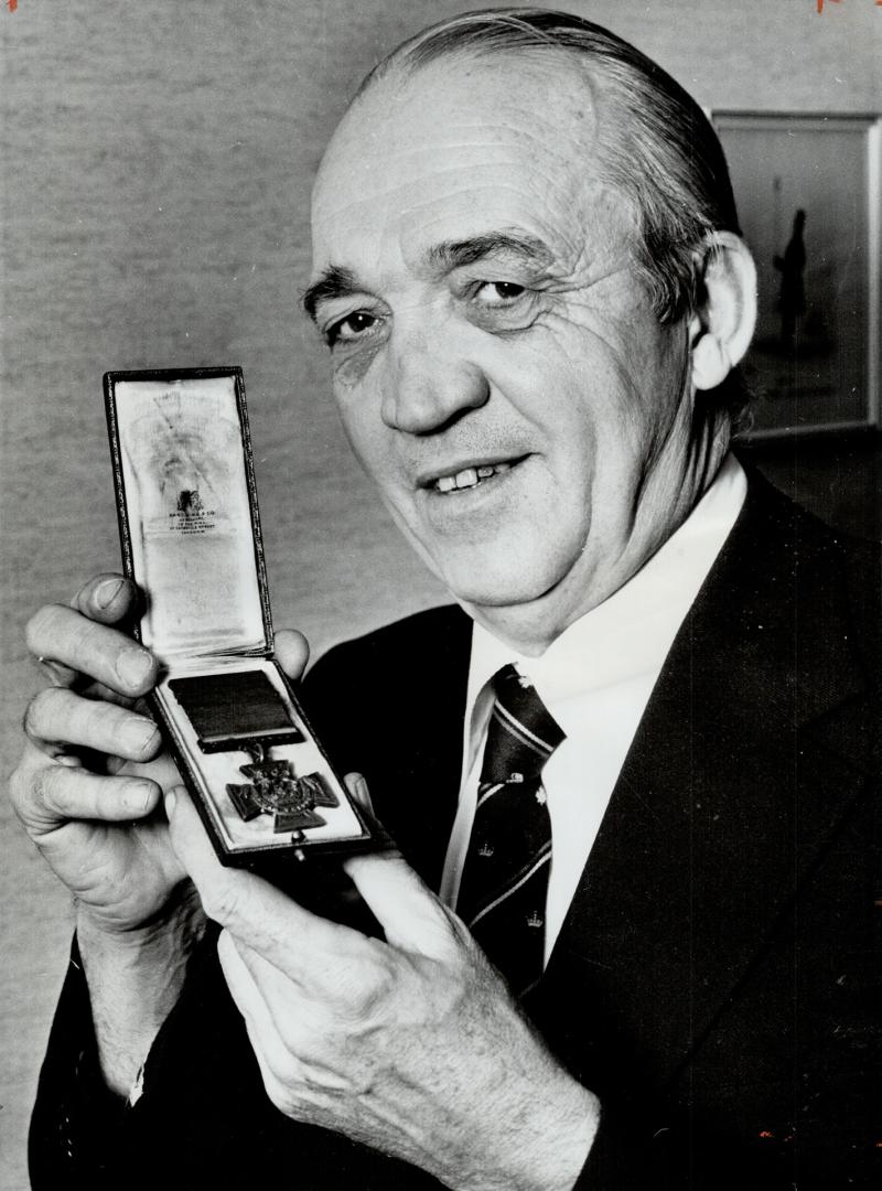 LT.-Col. William G. Heard, former commanding officer of Toronto Irish Regiment,, holds Victoria Cross of Edward Bellew of Vancouver, which was bought at British auction and given to Canadian Military Institute by Stephen Roman.