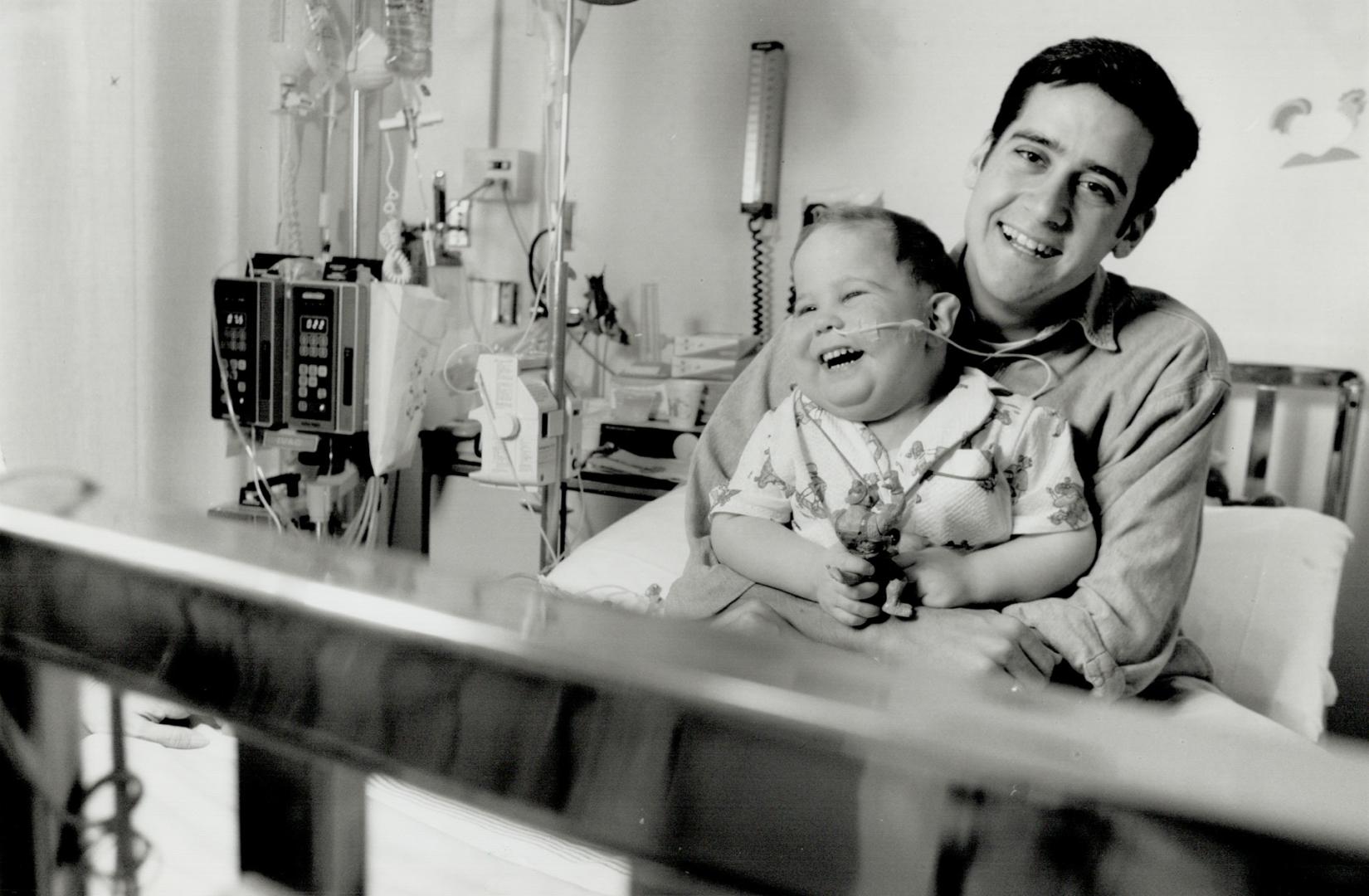 Buddies: David Hess embraces Jared Sadler, 4, at the Hospital for Sick Children.