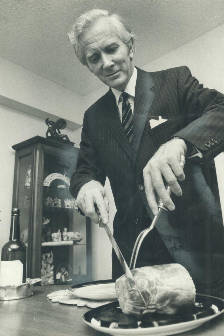 Host Hobbs Carves the Ham which he will serve to guests. As representative of wine company he must travel all over North America