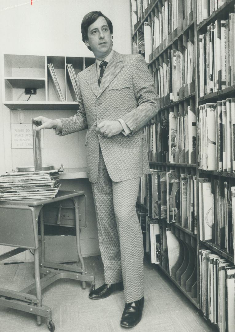 R. O. Horning, Jr., CFTR disc jockey broadcasting at Home Show, wears burgundy and white knit suit.