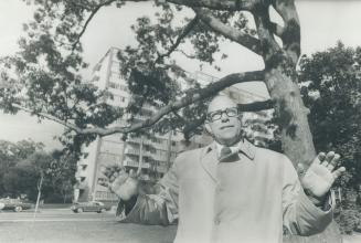 Dr. Erik Jorgensen, professor of forestry at the University of Toronto, stands under a gnarled oak tree at Avenue Rd. and St. Clair, an apartment high-rise in the background. New buildings are obliterating Toronto's sense of permanence and stability, he says, and the way to restore it is to cover the city with enduring trees.