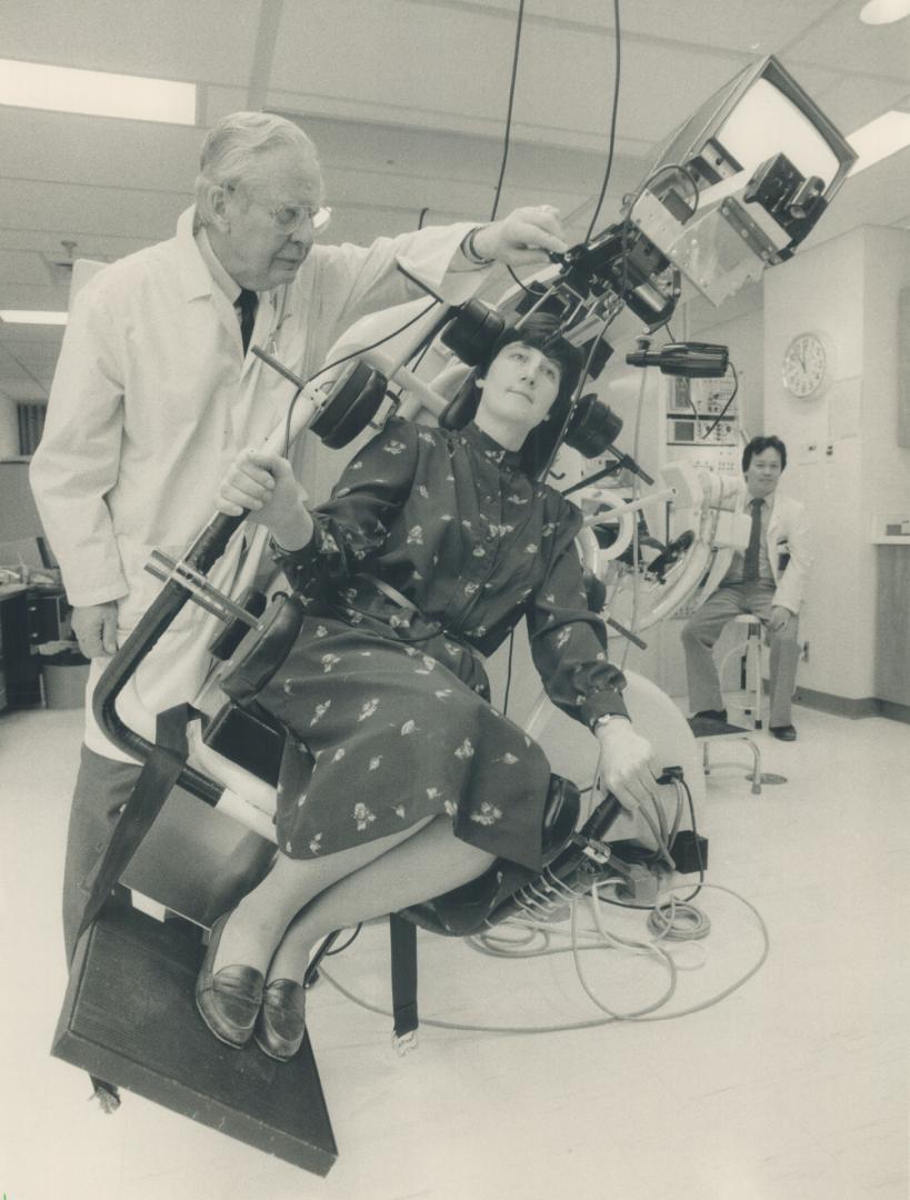 A question of balance. Technician Mary Yap takes to the tilting chair of balance expert Dr. Walter Johnson yesterday at St. Michael's Hospital. The otolith chair helps Johnson detect inner ear and balance problems. it was paid for by the Atkinson Foundation, which gave a $30,000 grant to St. Mikes to fund such research.