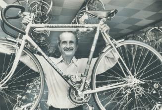 Paul Kent, self-styled bicycle King of Toronto, takes another bike from a rack in his Bloor St