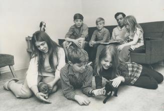 Here the Kirton Family enjoys a quiet moment in their living-room playing with two new kittens