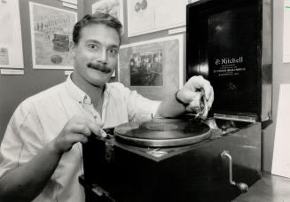 Museum Exhibit: Bowmanville Museum curator Dan Hoffman poses with a phonograph manufactured by the town's former Dominion Organ and Piano Company.