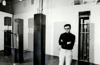 Chorus Ilne: Ihor Holubizkey, assistant curator of Harbourfront Art Gallery, stands beside one of Norman Andersen's modules, each of which contains organ pipes timed to go off randomly