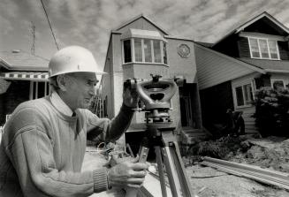 On the level: Ontario New Home Warranty Program inspector Jack Hussman uses a transit to check levels of a house under constrcution in Toronto