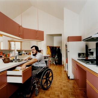 New house: John Israel, left, and his wife Pat both use wheelchairs, so they built a house from scratch with everything, including kitchen counters and sinks, at a 4 1/2-foot level