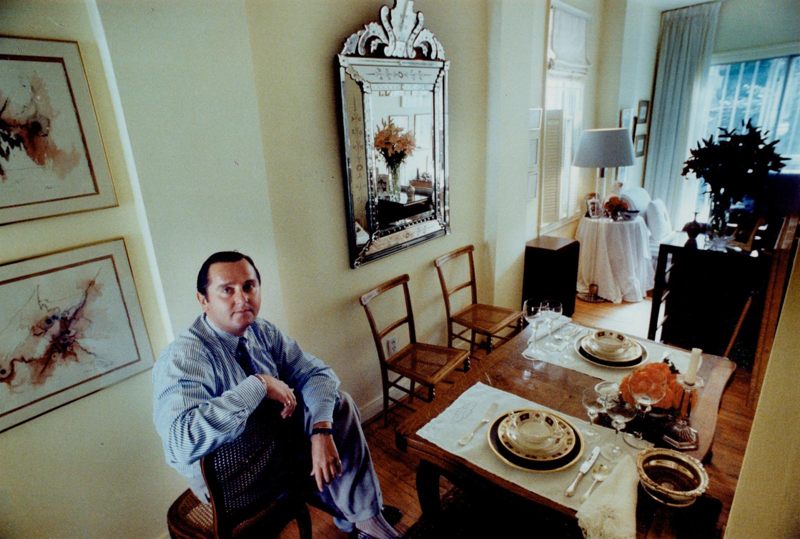 Tiny interior: Hair stylist Paul King surveys his narrow house from the dining area, which is not quite 6 feet wide.