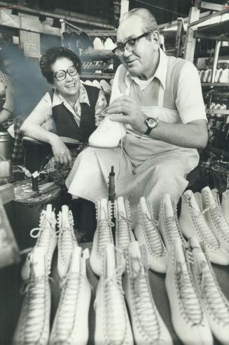 Steve Kolozsvary at his bench, watched by wife Rosa. An escaper from Hungary, master bootmaker now makes skates.