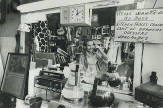 Street philosopher: Joe Leone, a retired Toronto barber, still gives haircuts to friends like Glen Wright, above, in his West End Junk shop, Crazy Joe's Flea Market