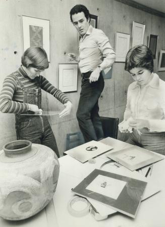 Preparing for their exhibition that starts today, Anne, Pedro and Anita Leon give finishing touches to pottery, abstract prints and drawings at Scarborough College's gallery