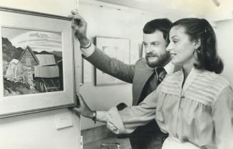 Anne and John Libby inspect a painting in gallery they created out of an old house