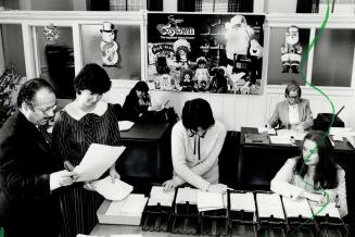 As head of Metro's Christmas bureau, run by the department of social services, Frank Kombargi, left, reads some distressing letters