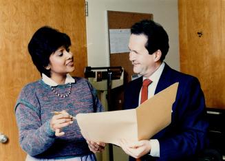 New program: Merle Jacobs, left, program co-ordinator for Branson Hospital's three-month-old program for eating disorders, discusses clinic with Dr. Fred Kroft, the hospital's head of psychiatry department.