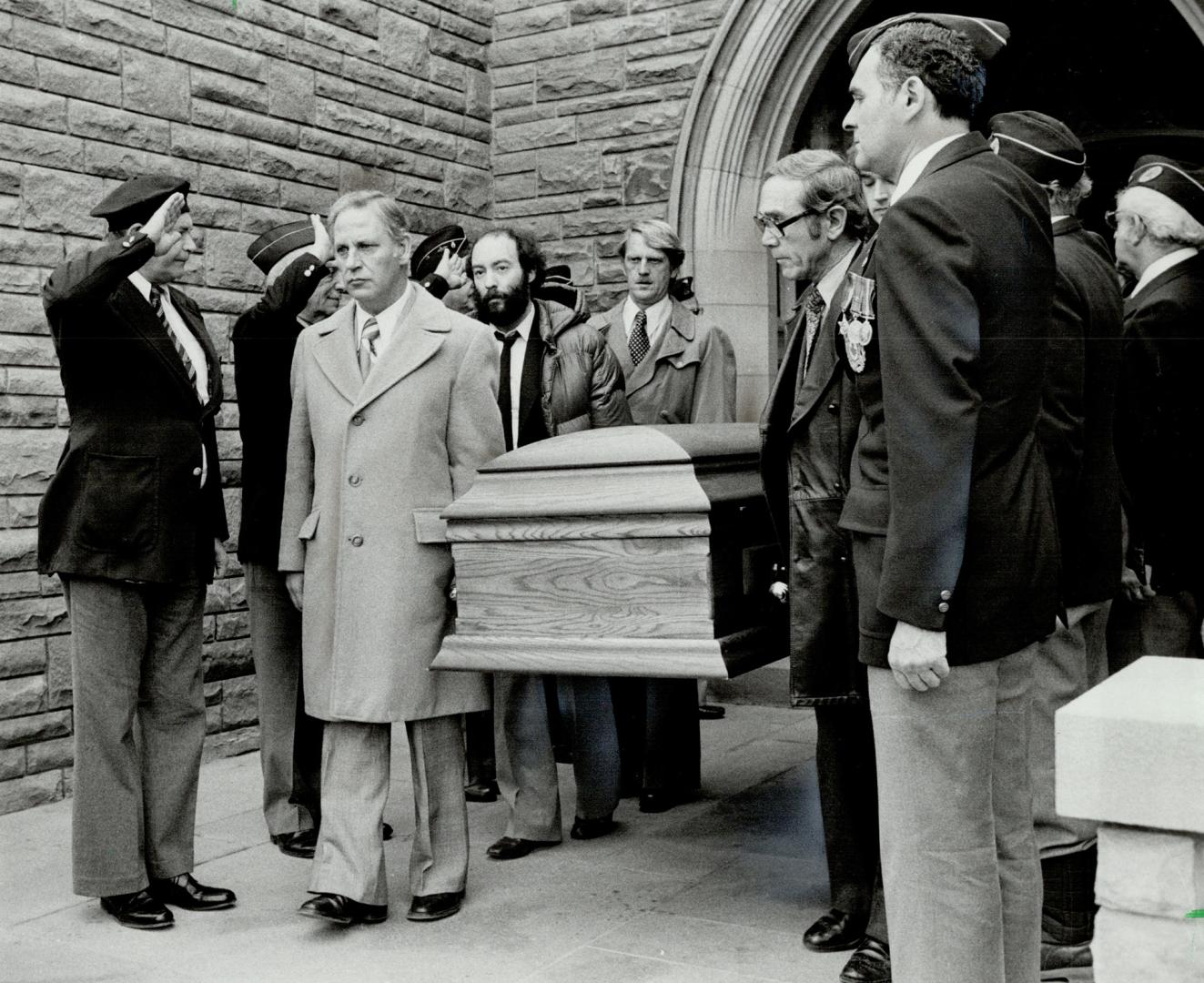 Quiet hero buried: The casket of Victor Kugler, who hid Anne Frank and seven others from the Nazis, is saluted by war veterans as pallbearers carry it from the funeral home yesterday