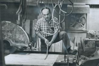 Paul Mably, above, produces small marble ornaments at the rear of a deserted house on Shaftesbury Ave