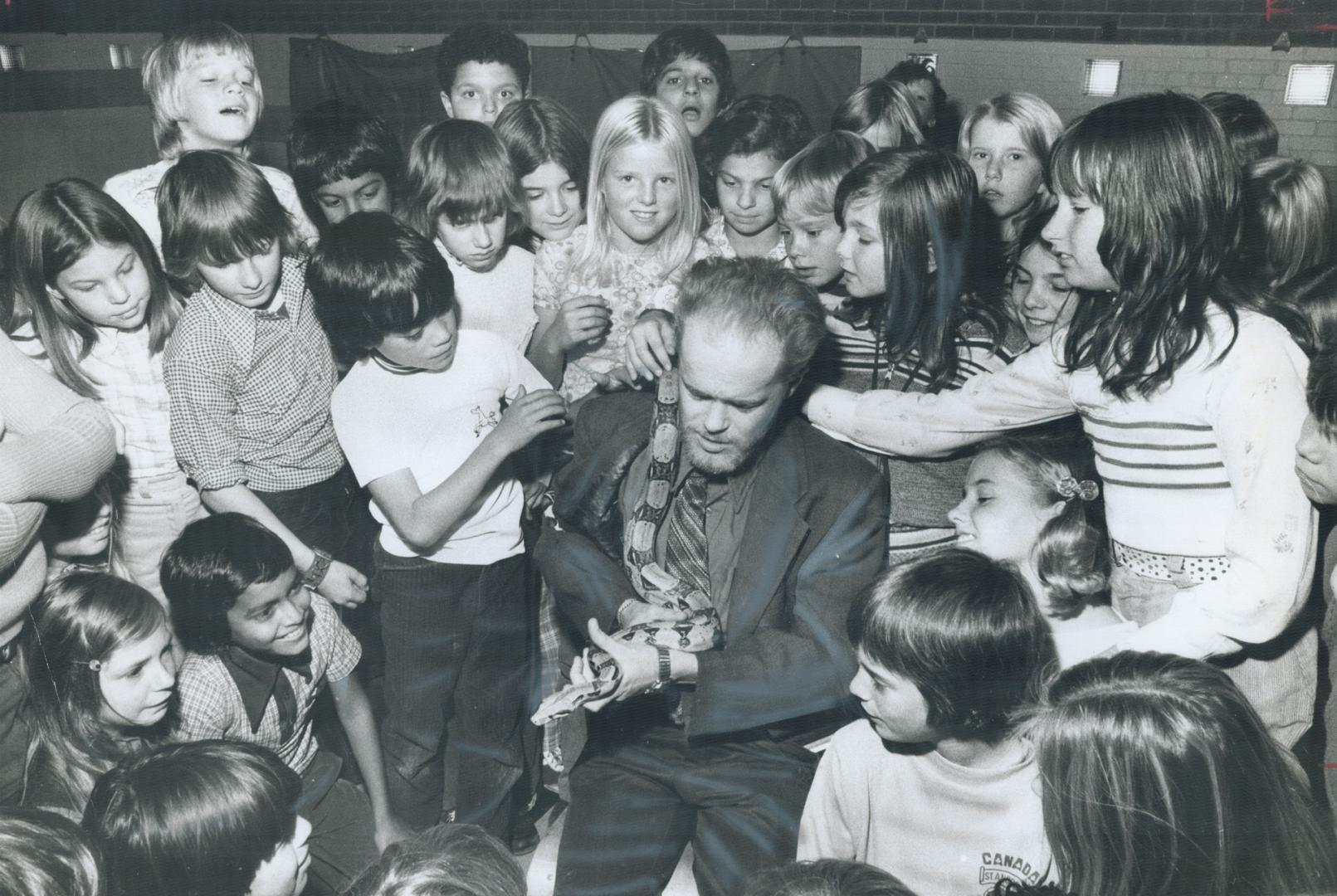 A Boa constrictor named Reuben, held by owner Bruce McBride, entertains Grade 5 pupils at Ellesmere Public School yesterday