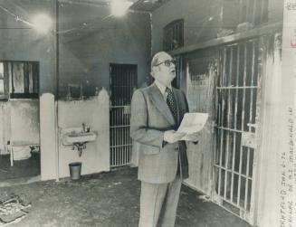 Area where fiv prisoners died in their cells in a fire during an investigation last month. The floor last Dec. 18 is still blackened by soot. Behind the coroner, Dr. A. broken and paint from the charred ceiling. Macdonald, is the rear entrance to the third-floor block, first men in Stratford jail call the area death row, officials said. [Incomplete]