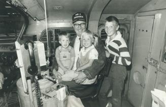 Number 1 hogger: Proudly wearing the hat bestowed on him by a collegue, Jim McEwen, 64, was greeted by many people - including his grandchildren - when he arrived in Toronto yesterday after making his last run from North Bay on CN