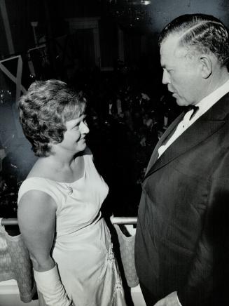 Mrs. Robert love talks to Frank McEachren. At Toronto Symphony's season opening party