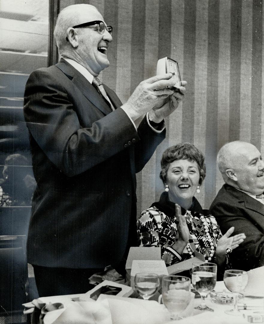 Mississauga Police Chief Garnet McGill holds the alarm clock given him as a joke at the dinner honoring veteran municipal employees