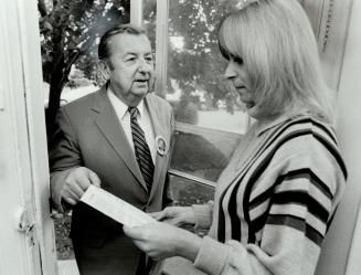 In the running: Real estate executive Herb McGroarty, 64, left, talks to householder Valerie Stapley about why she should vote for him as mayor of East York in the Nov