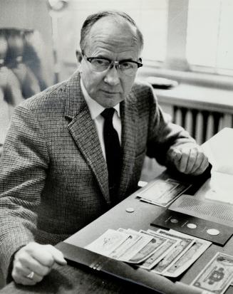 Now a professor of economics at Atkinson College at York University, Dr. Alex N. McLeod has made a life-long study of the open economies of the world, such as Canada. On desk is part of collection of currencies of nations he studied.