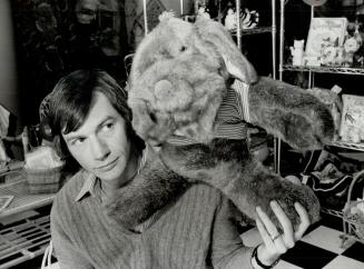 Cuddly canine: John McLean, owner of Melodies, checks out a stuffed dog in his Adelaide St. E. gift shop which also incorporates a restaurant.