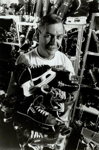 Shelves of skates: George Mackay holds some of the 300 pairs of skates he keeps in the basement of his Brampton home.