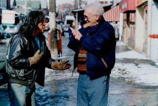 He was there: Joe McNamara, right, formerly a homeless alcoholic and now a tireless downtown street worker, chats with Red Dog, 52, who sleeps on Toronto's warm air grates