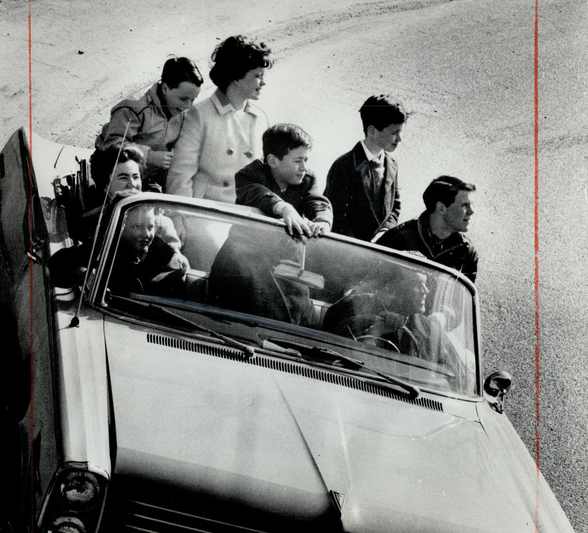 Craning from a convertible is best way to see metro area. Mr and Mrs. L. R. H. Matthews and Mr. and Mrs. D. G. Matthews plan holidays