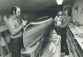 Varnishing act: Ted Moores has a loving audience as he applies yet another coat of resin to one of his classic canoes