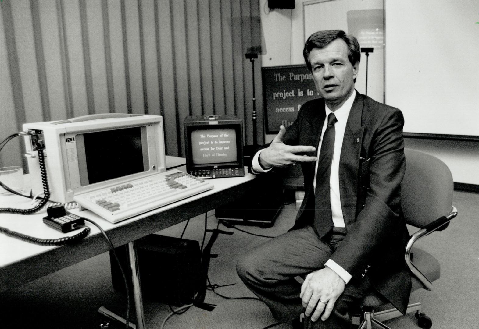 Equality through tehchnology: Denis Morrice of the Canadian Hearing Soceity displays a device that letws the deaf read whatever a teacher is saying.