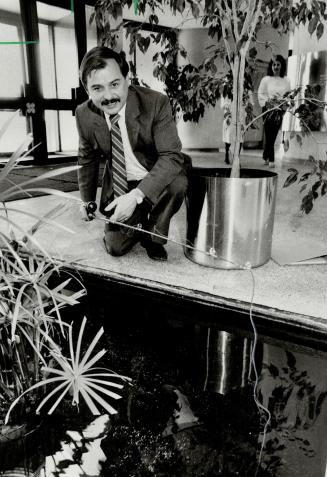 The worm turns: John Morand, Scarborough's economic development commissioner, fishes the Civic Centre's reflecting pool while pondering his rather fishy tourism plan