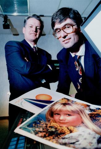 MGL owners Paul Moravec, right, and Al McFarlane display color copy from one of their copiers.