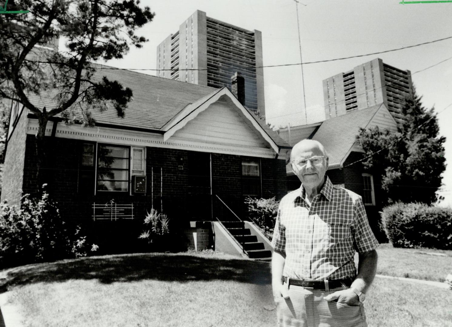 Progress in bloom: Mert More stands in front of his home - the first post-World War II home built in rural village of Lansing in 1947 - which sits one short block away from Sheppard Ave