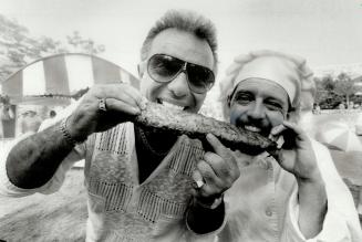 Owner Ted Nikolau, left and chef Brian Williamson of J.J. Muggs try the winning ribs at the Battle of the Barbecues contest.