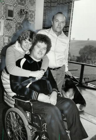 Small consolation: Manfred Mueller, 22, gets a hug from his mother, Elisabeth, while his father, Heinz, looks on