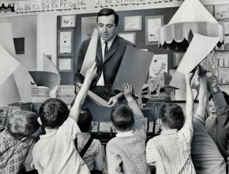 All hands are up as Don Mullin - Ontario's only male kindergarten teacher - conducts a class at Scarborough's St