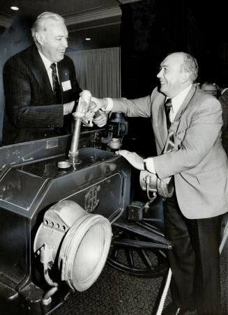 Fill 'er up: William MacKinnon, president of Ontario Trucking Association, left, and Charles Munro, president of International Harvester Co