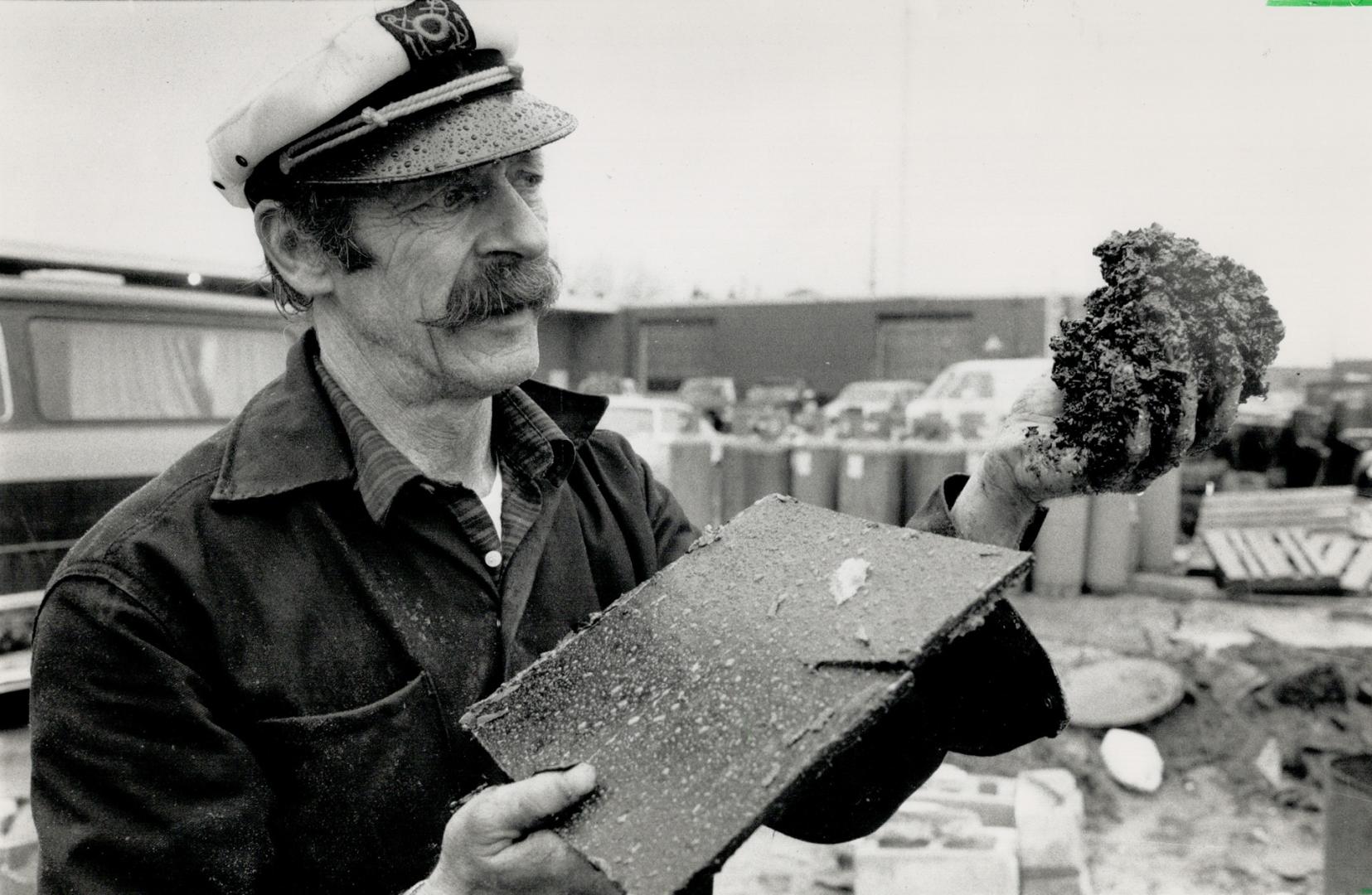 The wax man: Willy Nelson shows how his hot wax application for picking up spilled oil can sop up oil sludge, held in his right hand, and turn it into a waxy misture, in his left hand, solving an environmental crisis