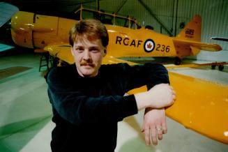 Keeps' Em flying: Maurice Nesbitt works on vintage planes at Oshawa airport.